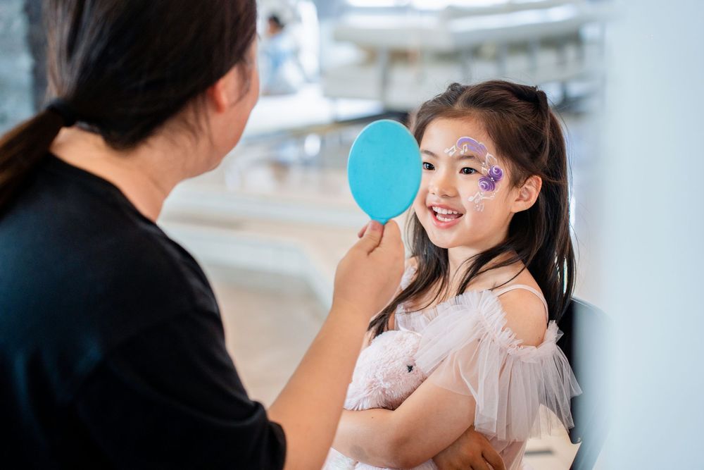 Auckland kids party photography capturing face painting activities and beautiful party food details.Auckland kids party photography capturin
