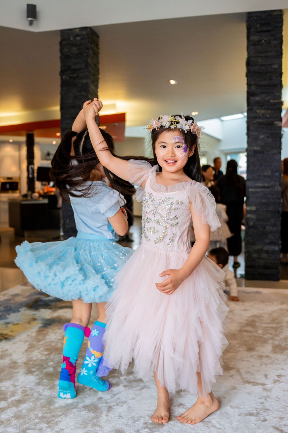 Two happy girls in beautiful princess dresses celebrating at a kids birthday party on the North Shore, Auckland.