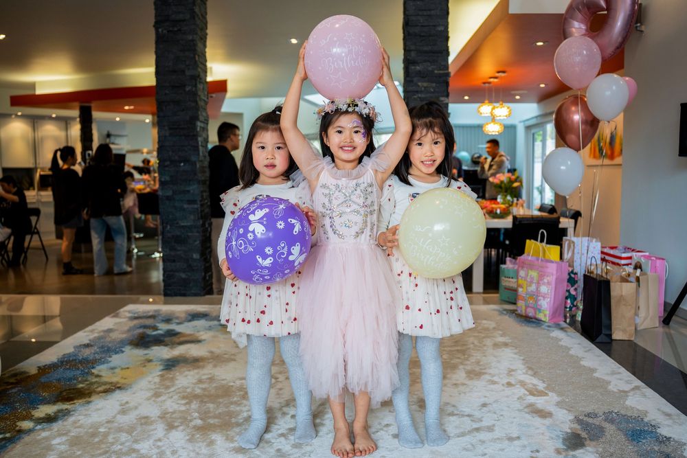 Two happy girls in beautiful princess dresses celebrating at a kids birthday party on the North Shore, Auckland.