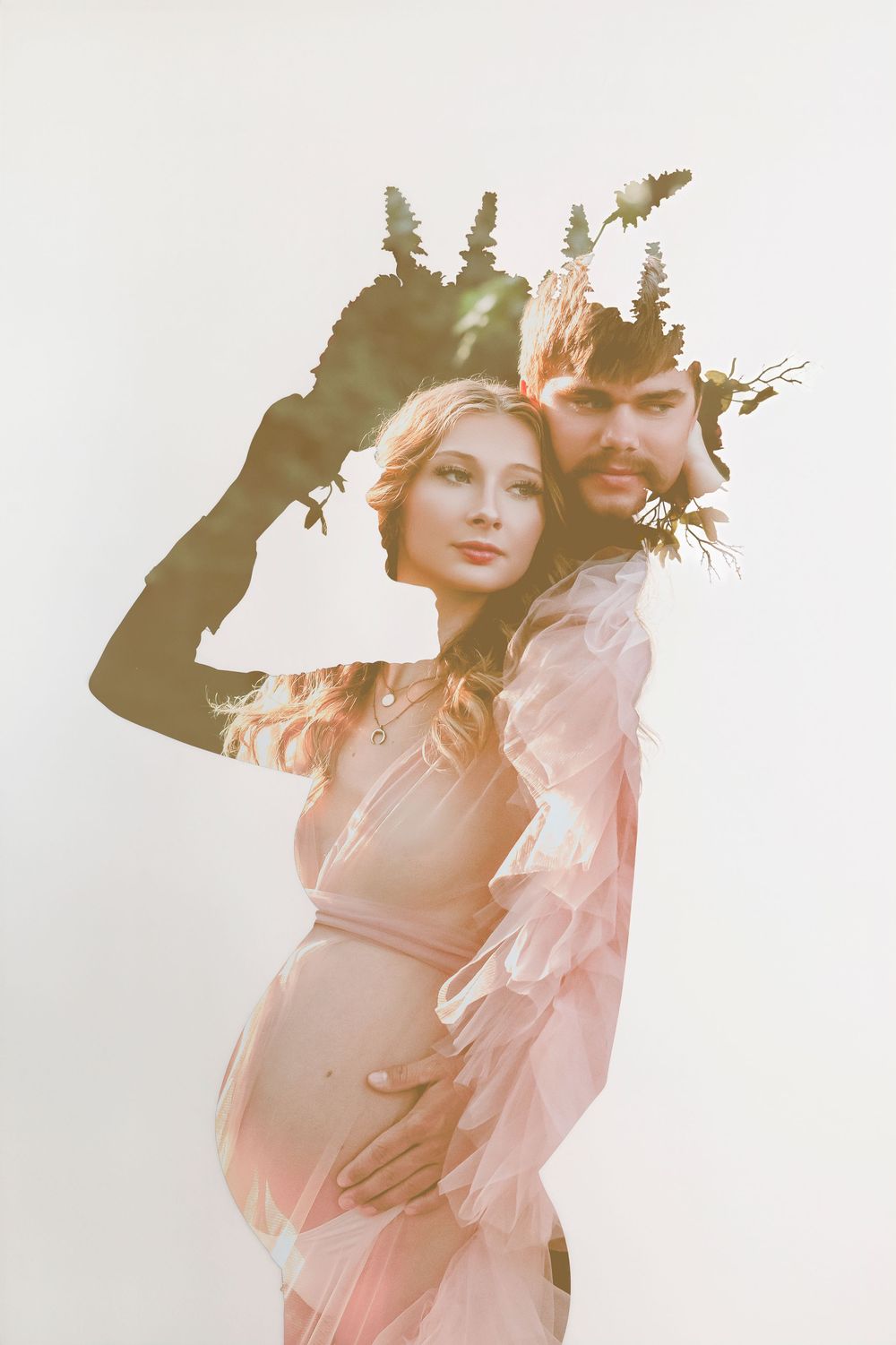Double exposure portrait of pregnant couple with floral crown on light background.