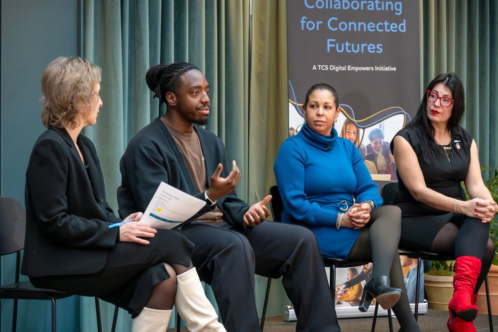 A group of people sitting together in chairs during a collaborative meeting or discussion session.