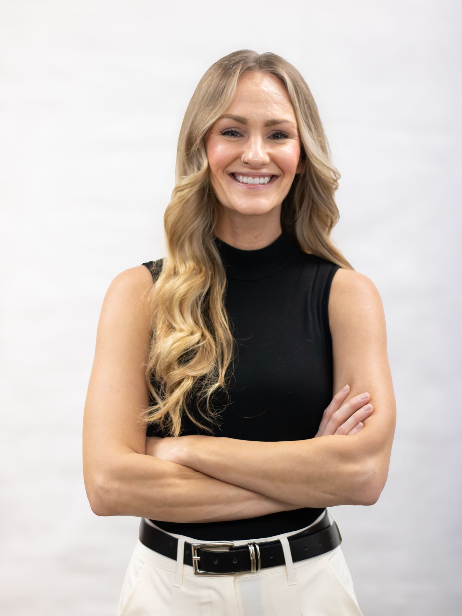 Woman smiling crossing arms for business portraits.