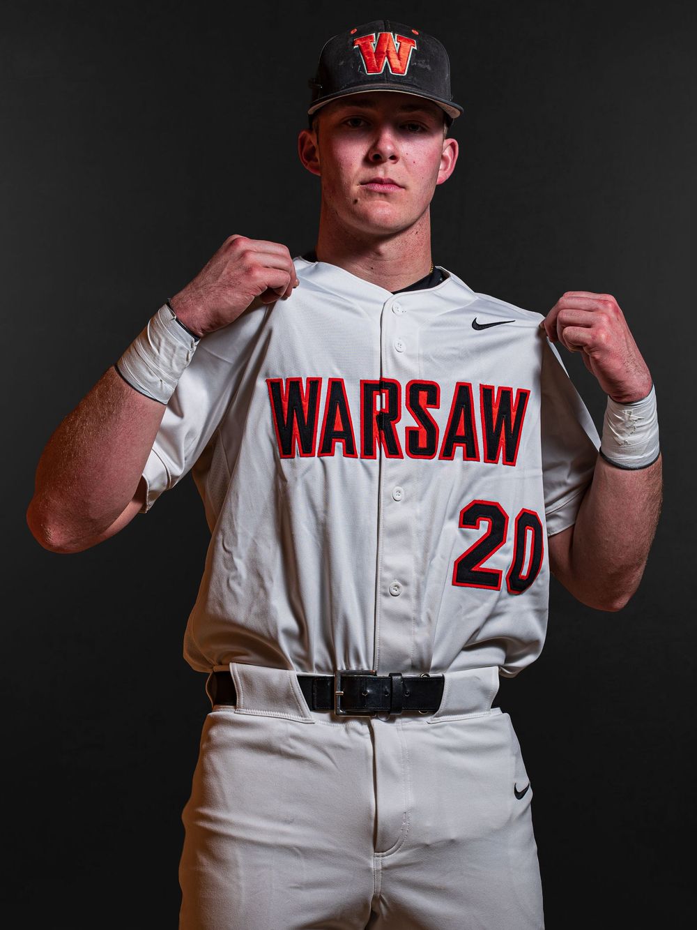 Team Media Day Photo of baseball player wearing uniform number 20 poses in dramatic studio portrait - Warsaw, Indiana