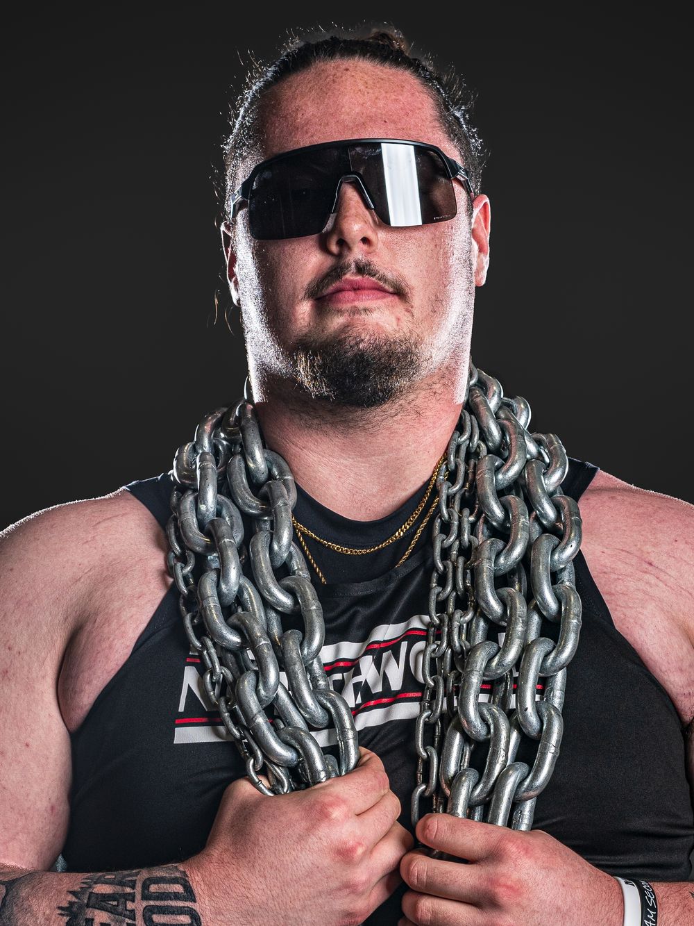 Dynamic Team Media Day Photo of athlete wearing sunglasses poses with heavy chain around neck in dramatic portrait - Nappanee, Indiana