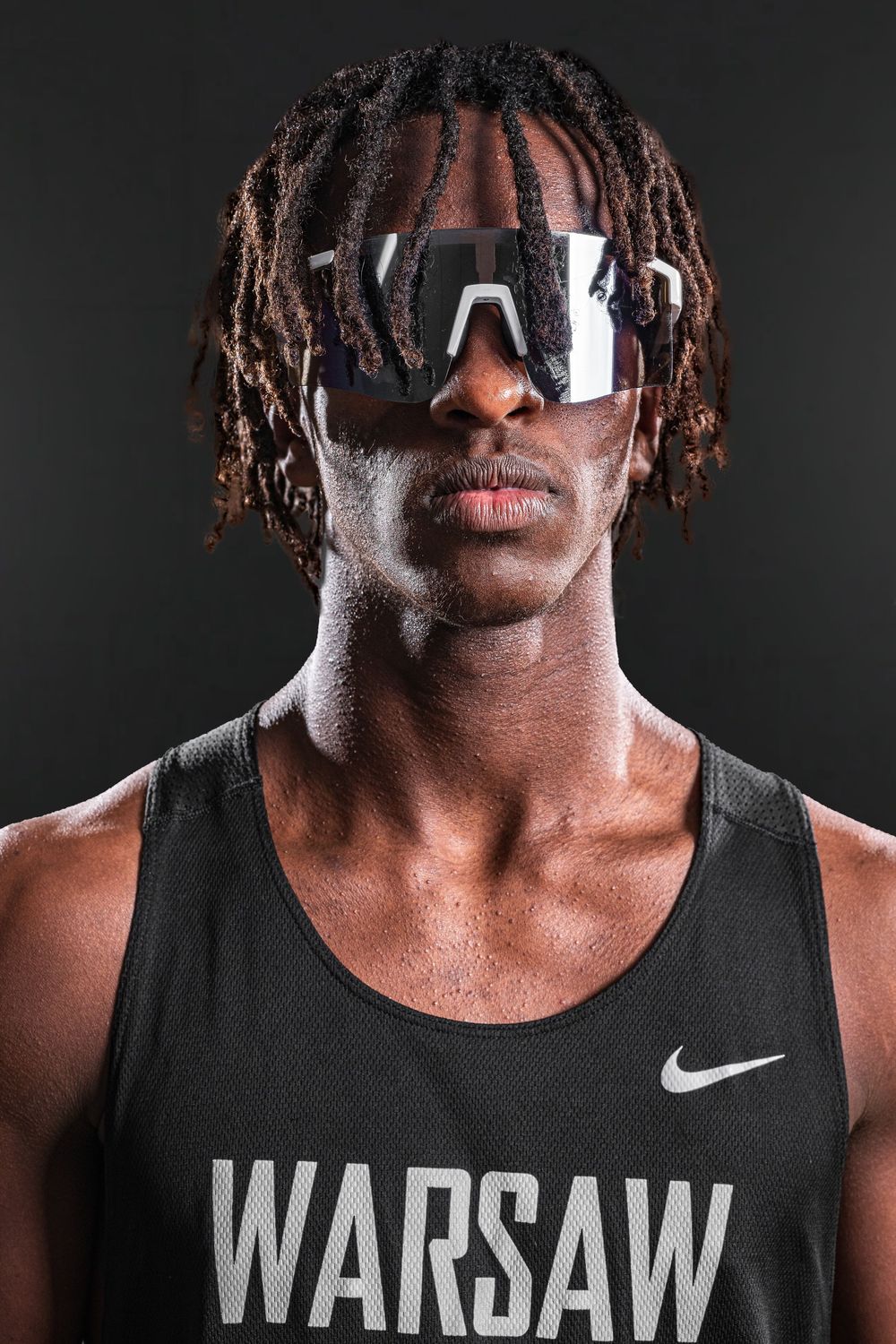 Team Media Day Photo of a close-up portrait of an athlete wearing sunglasses and Warsaw tank top against dark background - Warsaw, Indiana