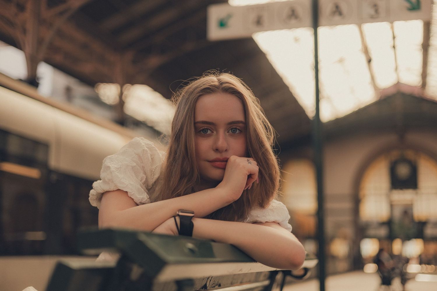Artistic indoor portrait with soft natural lighting and vintage aesthetic.