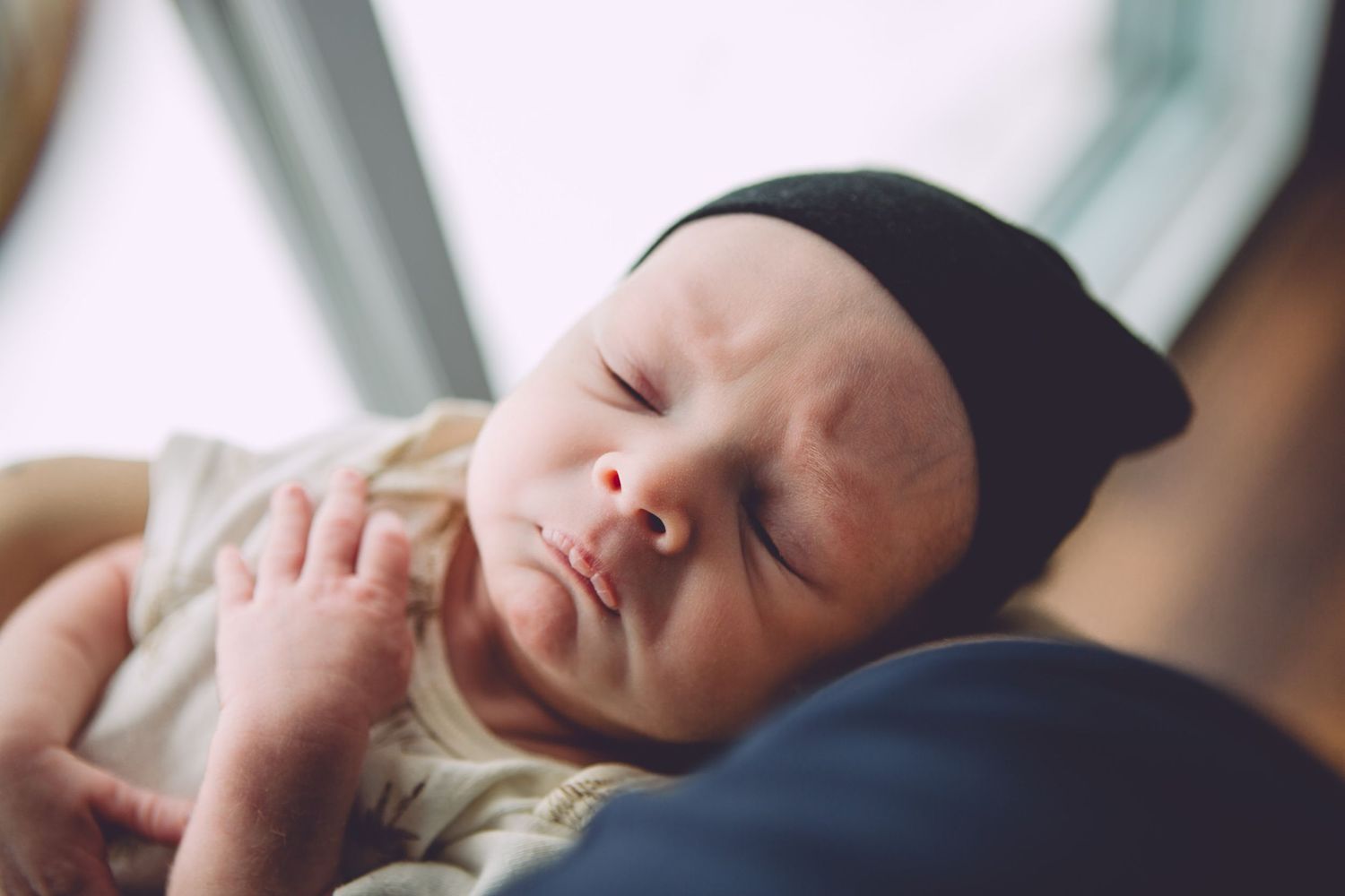 Intimate newborn photography series showing peaceful sleeping moments.