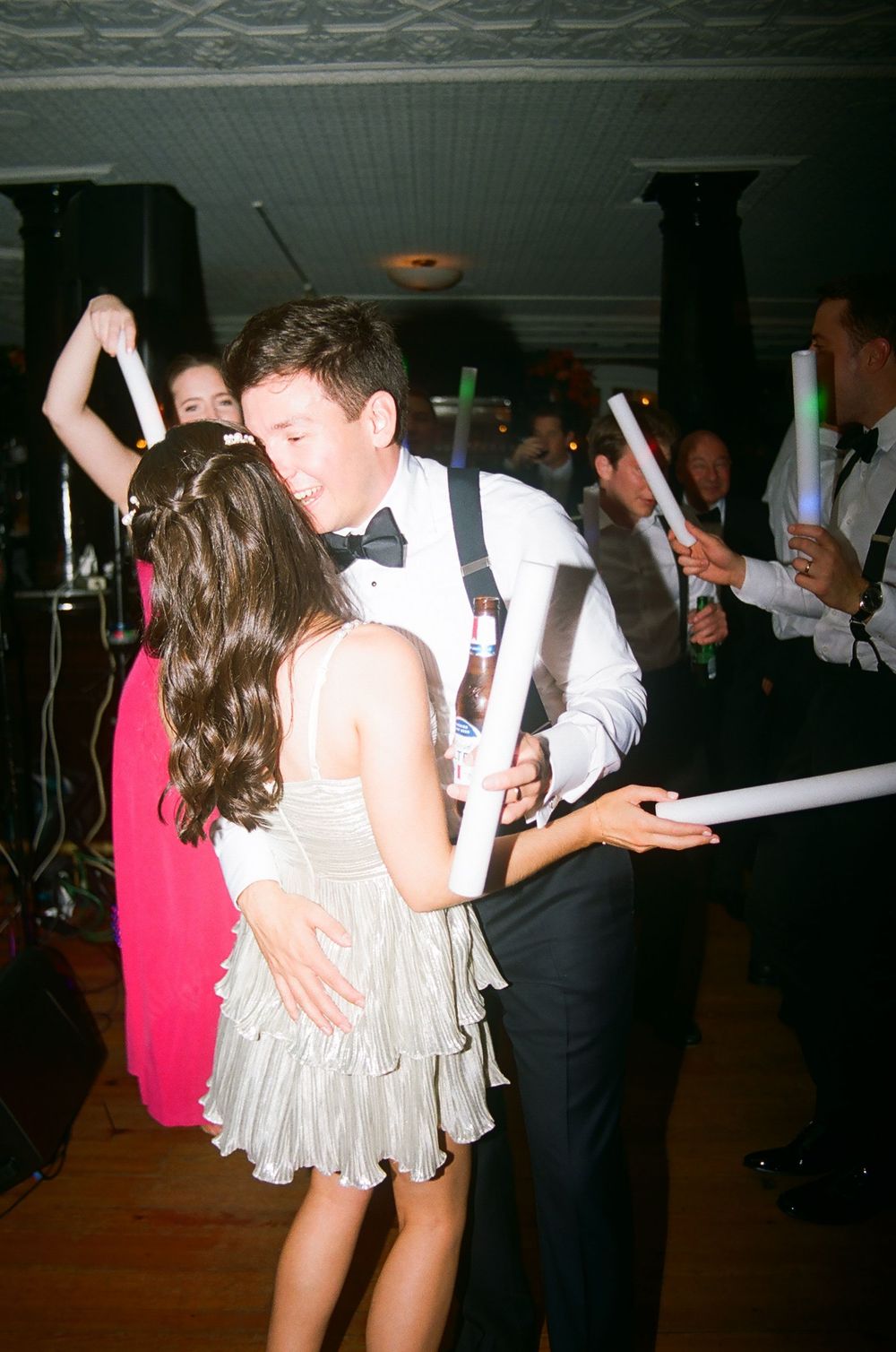Wedding reception dance floor with guests celebrating in formal attire.