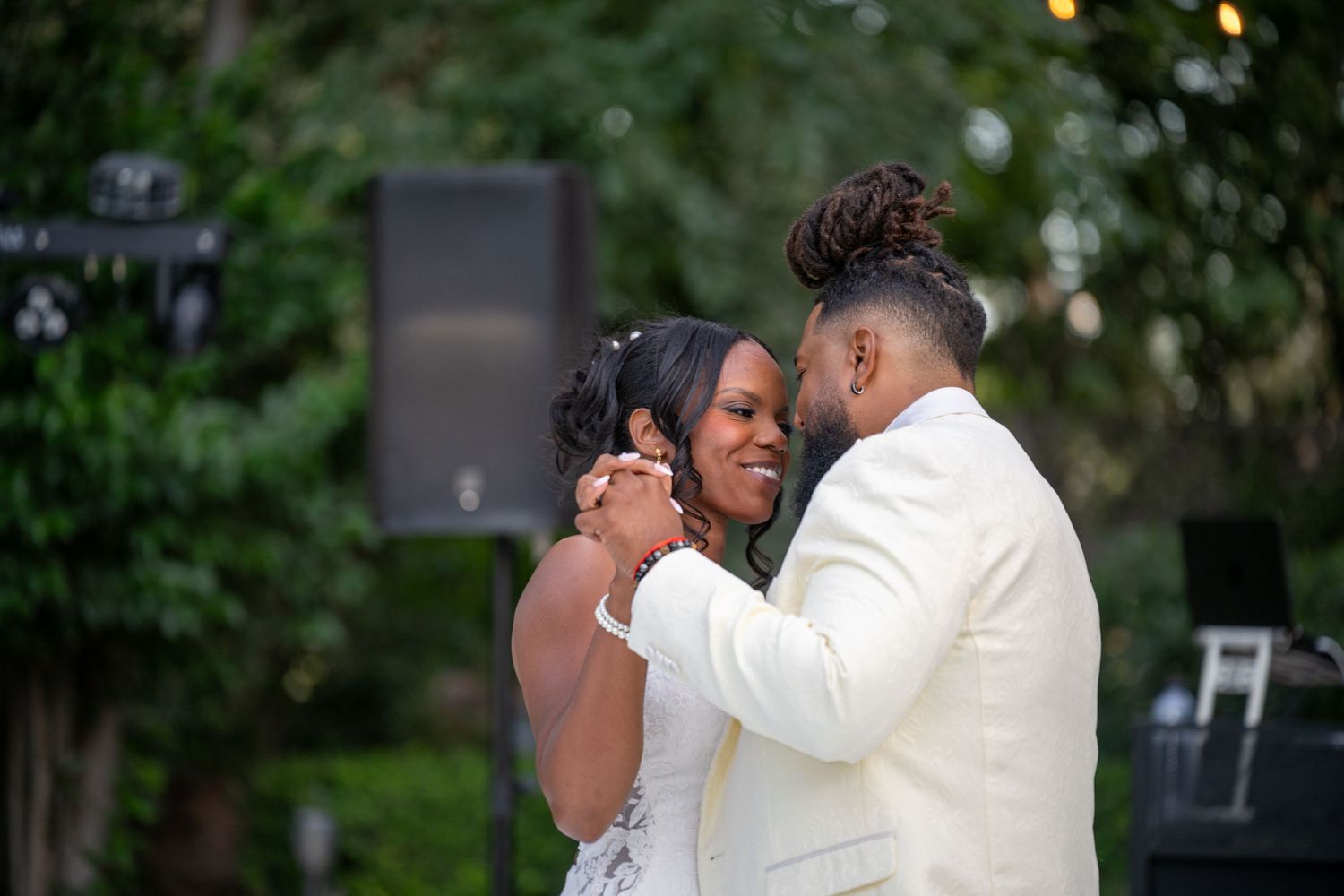 Romantic first dance moment at an outdoor evening wedding reception.