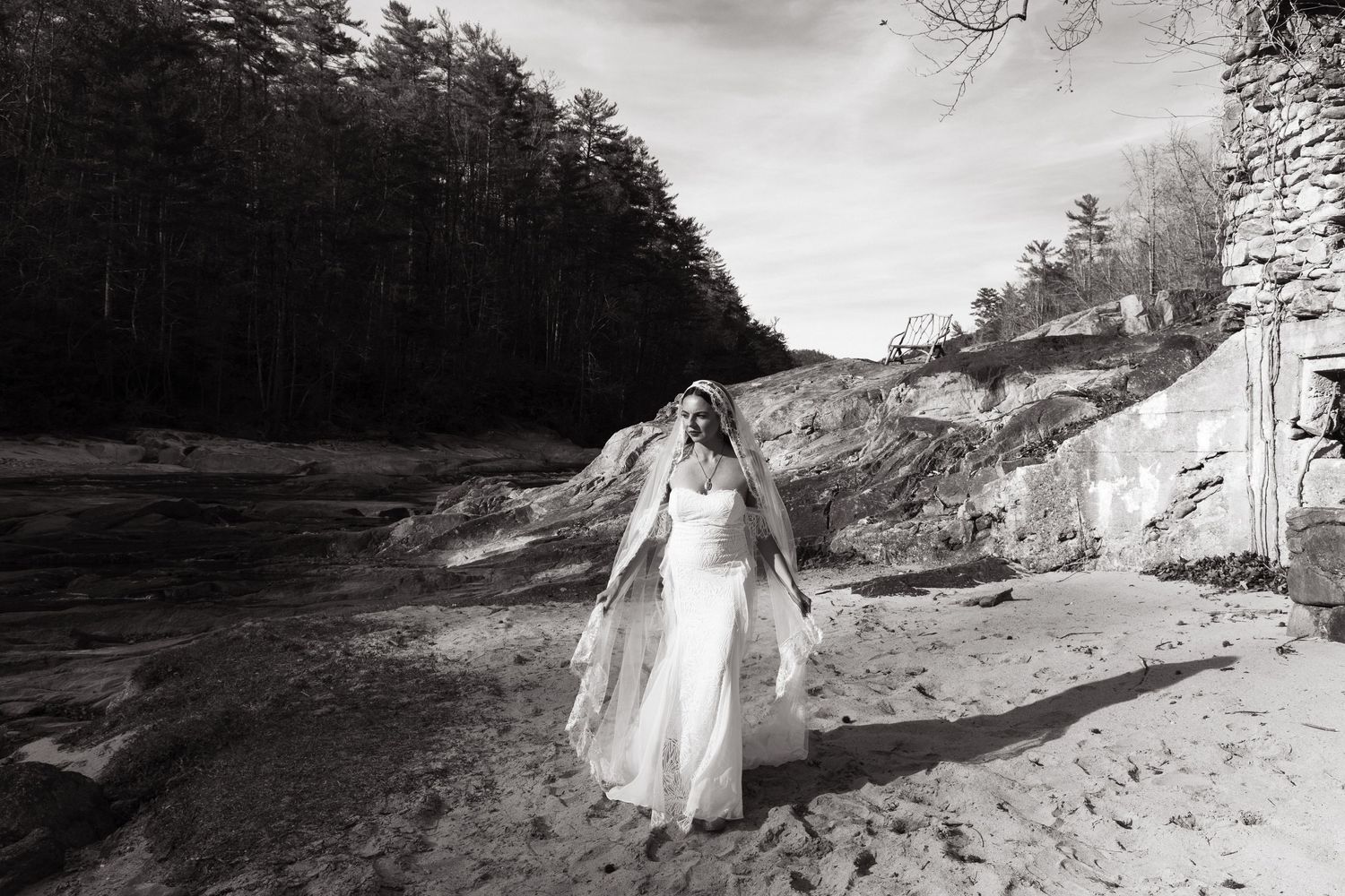 A sequence of black and white images showing a figure in white walking along a dirt path near trees.
