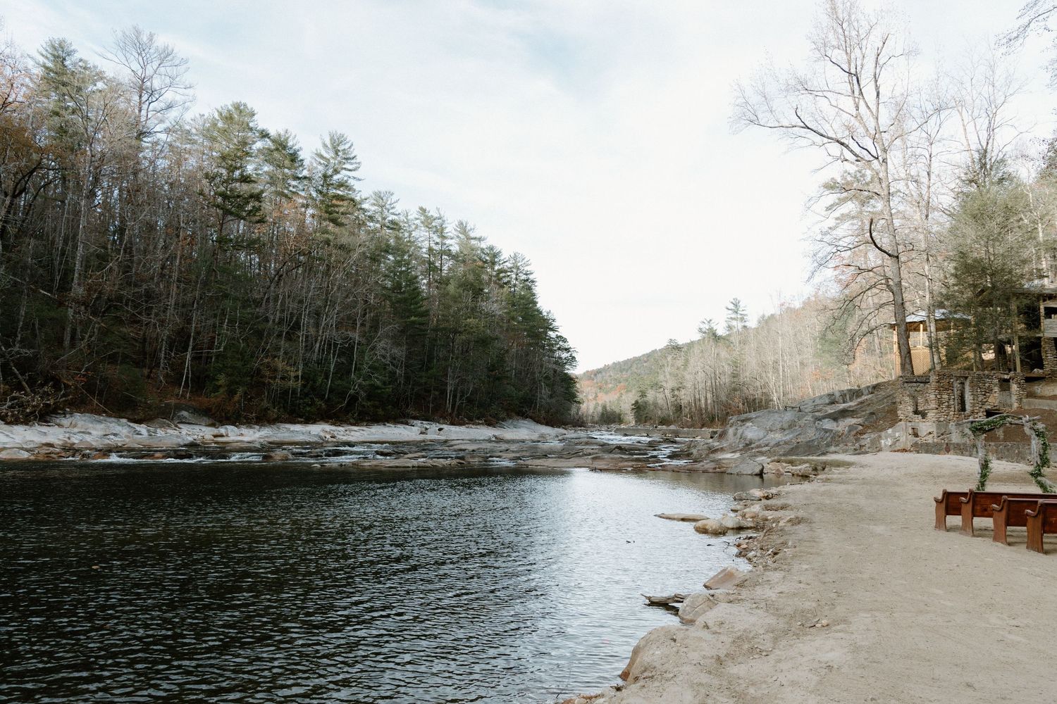 A panoramic view shows scenic forest and waterfront landscape with a serene lake stretching into the horizon.