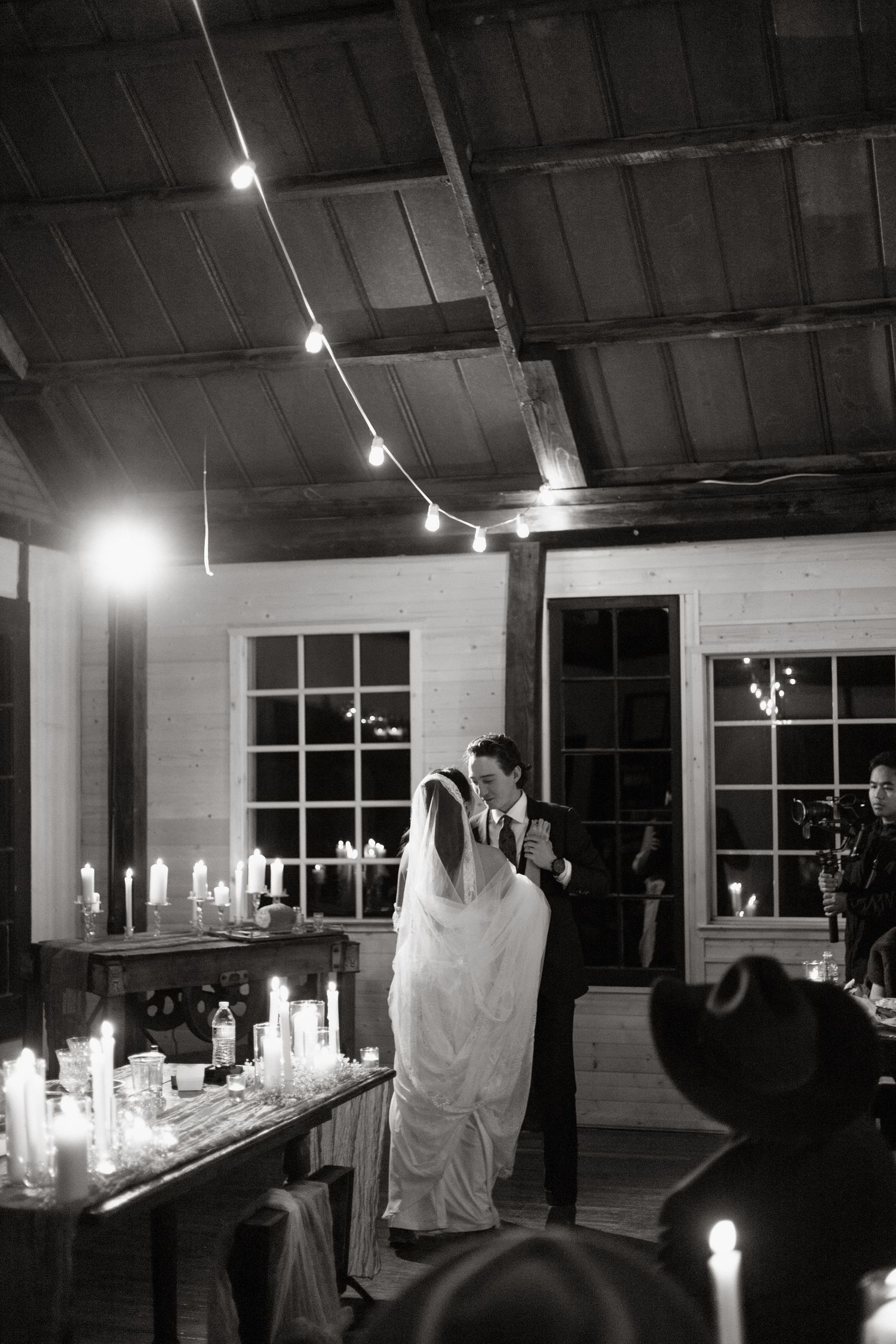 A spooky series of candlelit scenes with ghostly white sheets draped over furniture in a dark room at night.