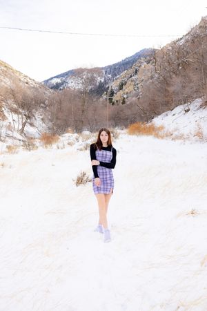 Winter fashion portraits in snow-covered mountain valley.