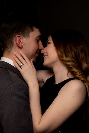 Close-up romantic portraits in dark moody studio lighting.
