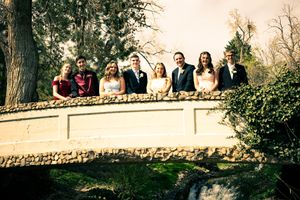Large group gathered on stone wall for outdoor photo session.