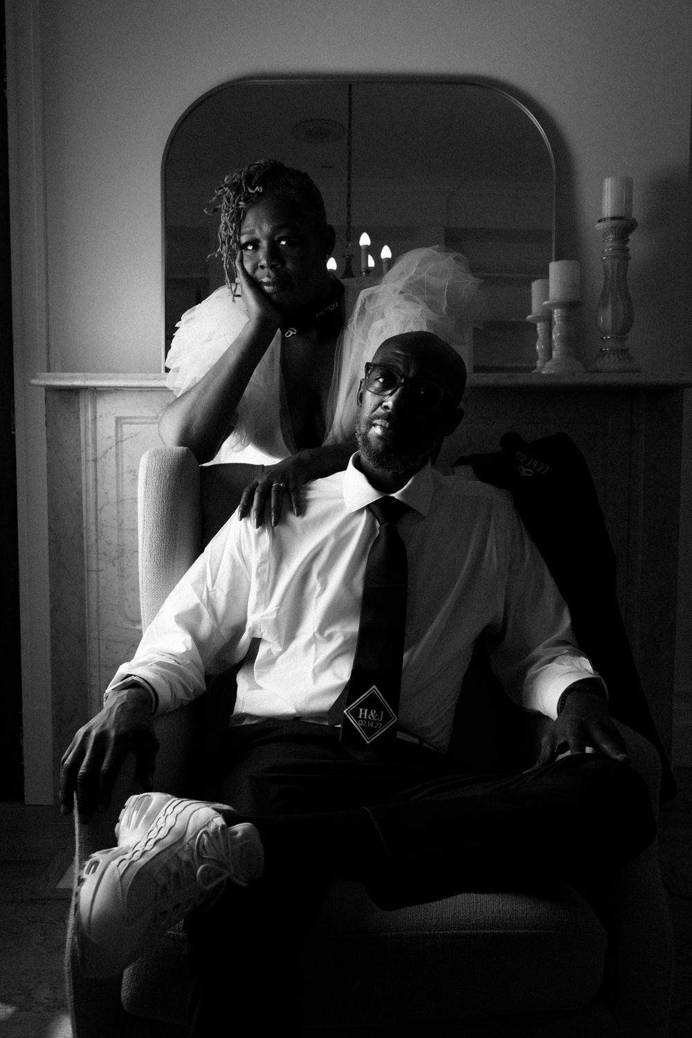 Dramatic black and white film noir style portraits of a person seated in moody lighting and shadows.