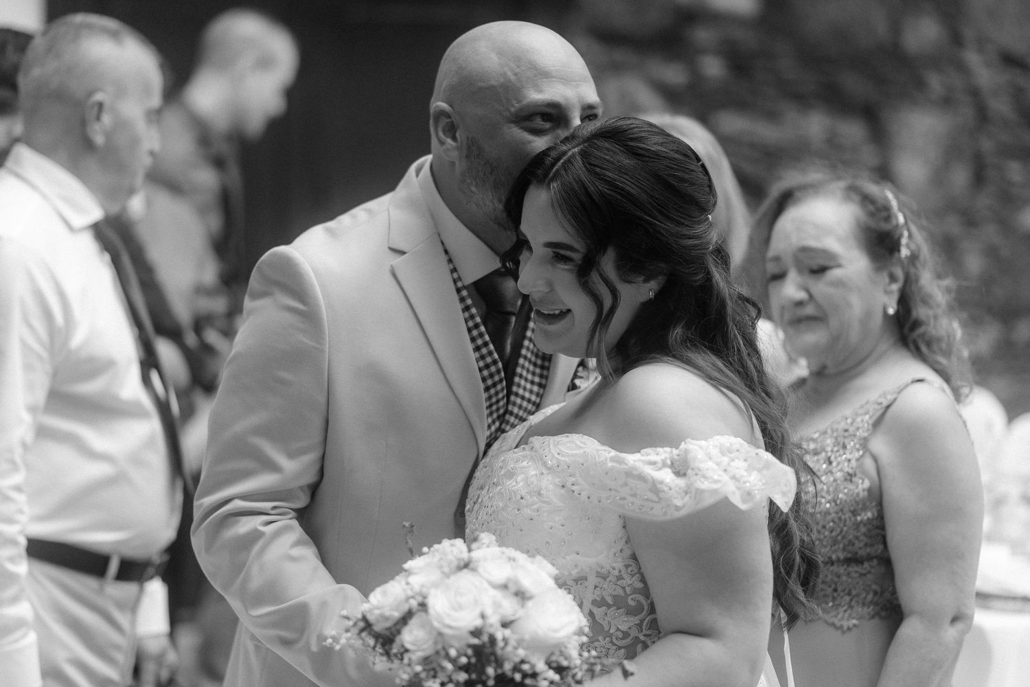 Black and white photo collage showing tender moments between couples during a formal wedding celebration.
