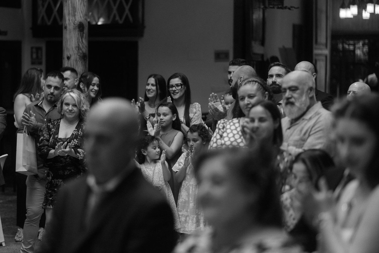 A black and white photograph of a crowd gathered inside during a church or ceremonial event.