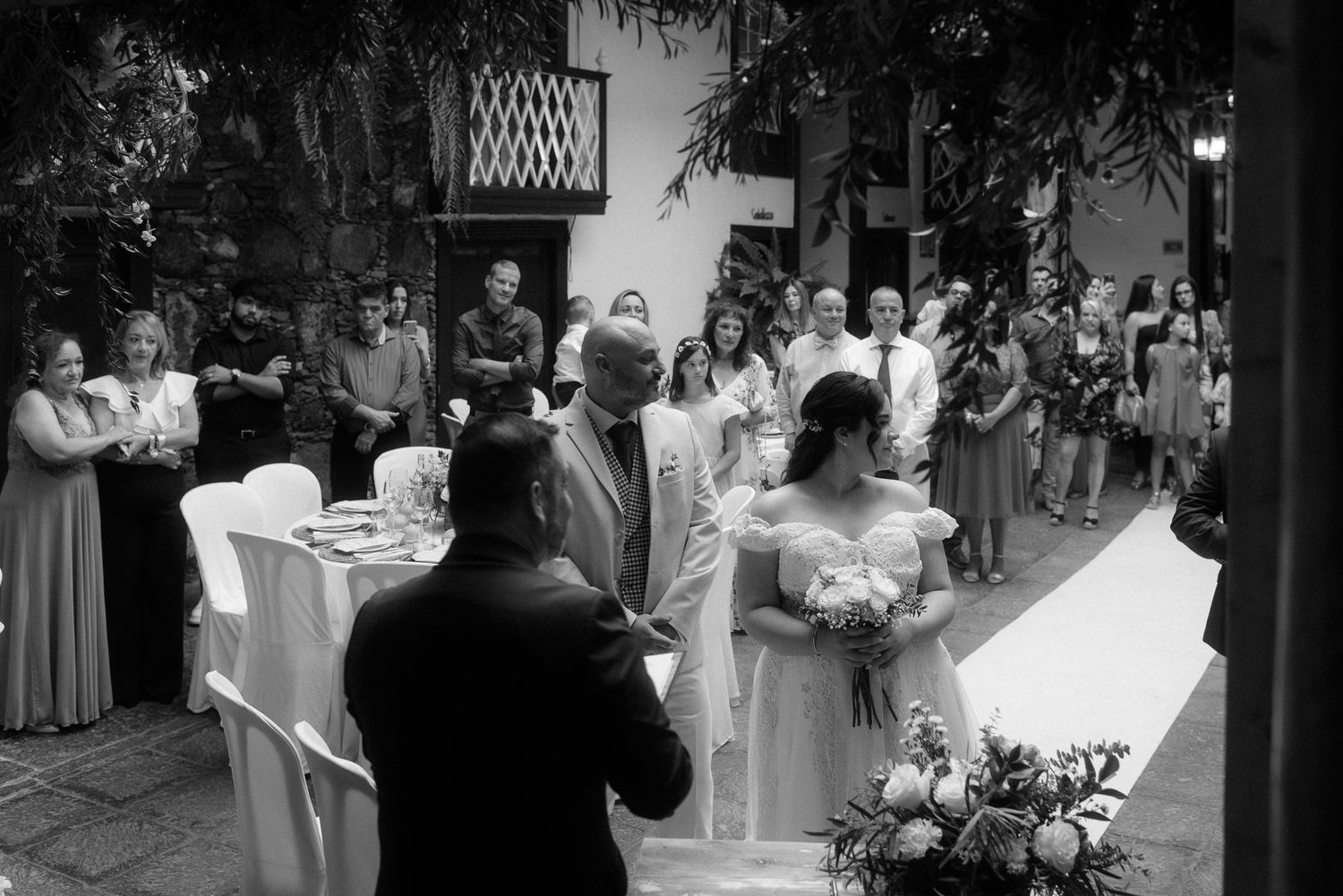 A black and white photo collage showing multiple scenes from a formal wedding celebration.