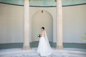 Wide shot of a bride's dress train on the steps of the pool house of Hacienda de las Flores in Moraga.