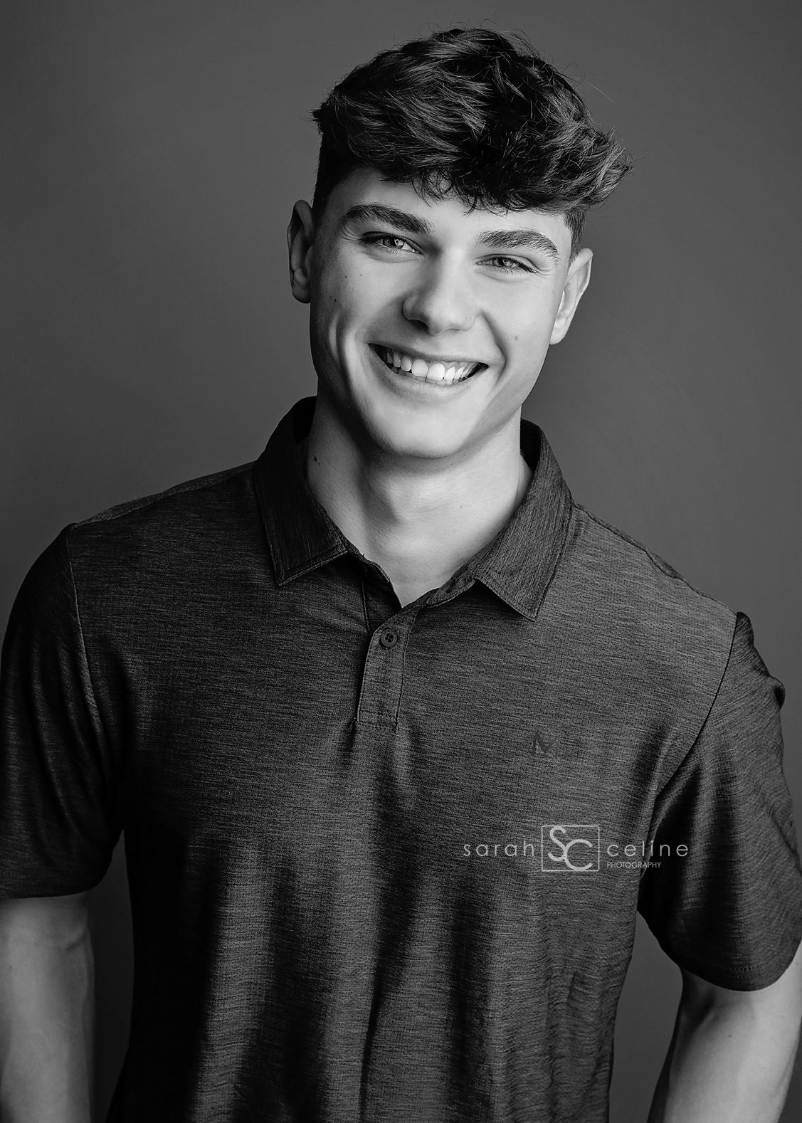 A person wearing a dark collared polo shirt poses for a series of black and white professional headshots.