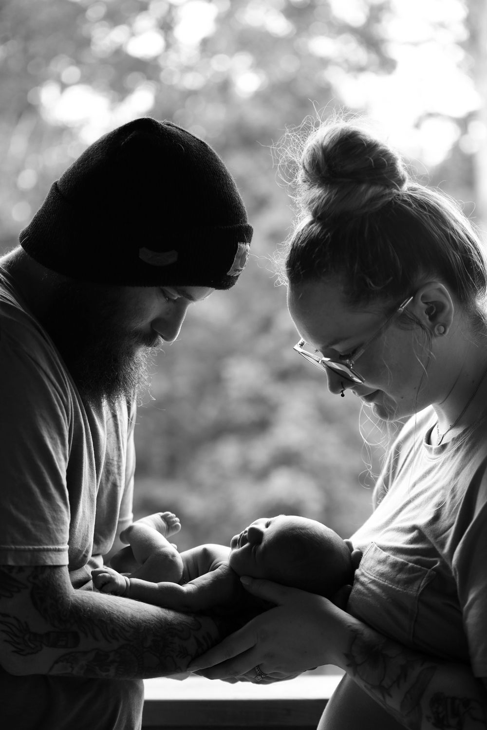 A series of black and white photos showing two artists creating art together in a sequential progression.