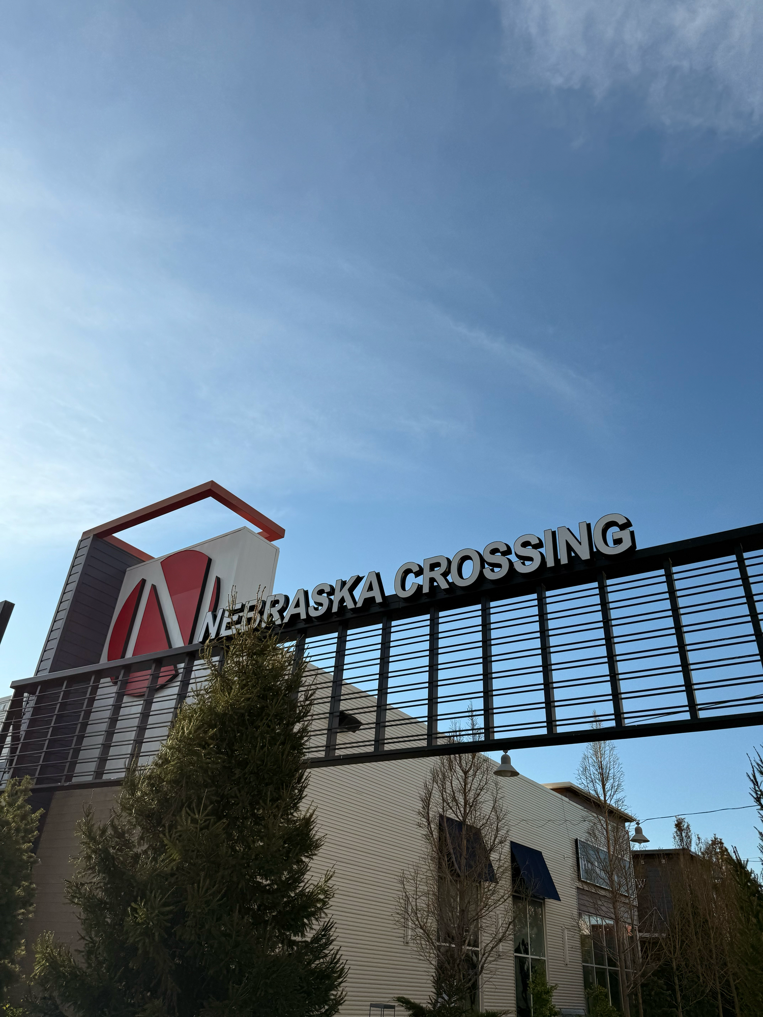 Nebraska Crossing retail outlet mall entrance sign and building exterior.