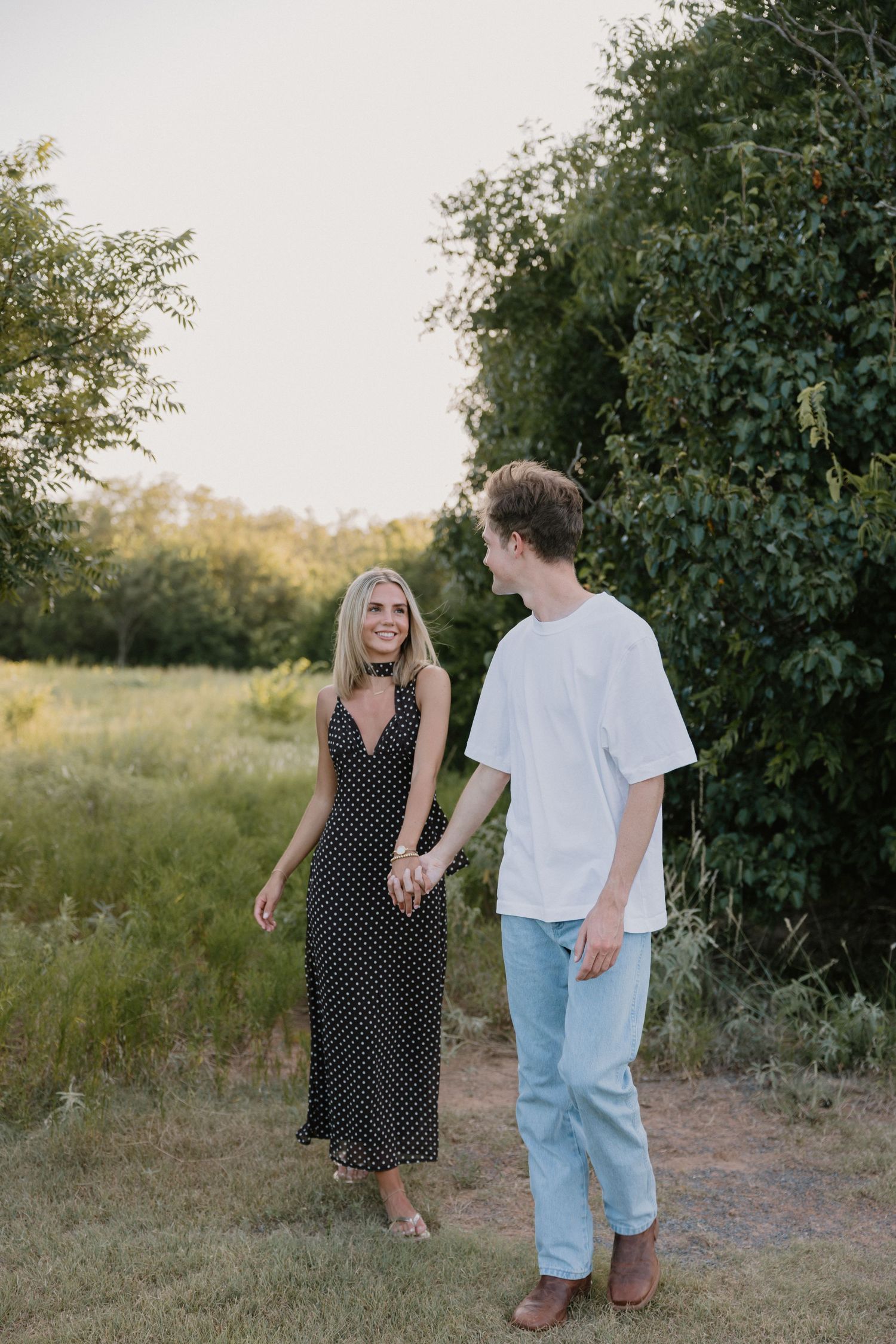 A romantic black and white intimate moment between a couple as they share a tender embrace outdoors.