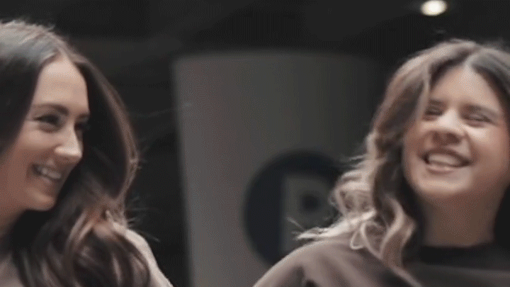 Three confident women showcase new apparel in a raw industrial setting, blending edgy style with modern fashion.