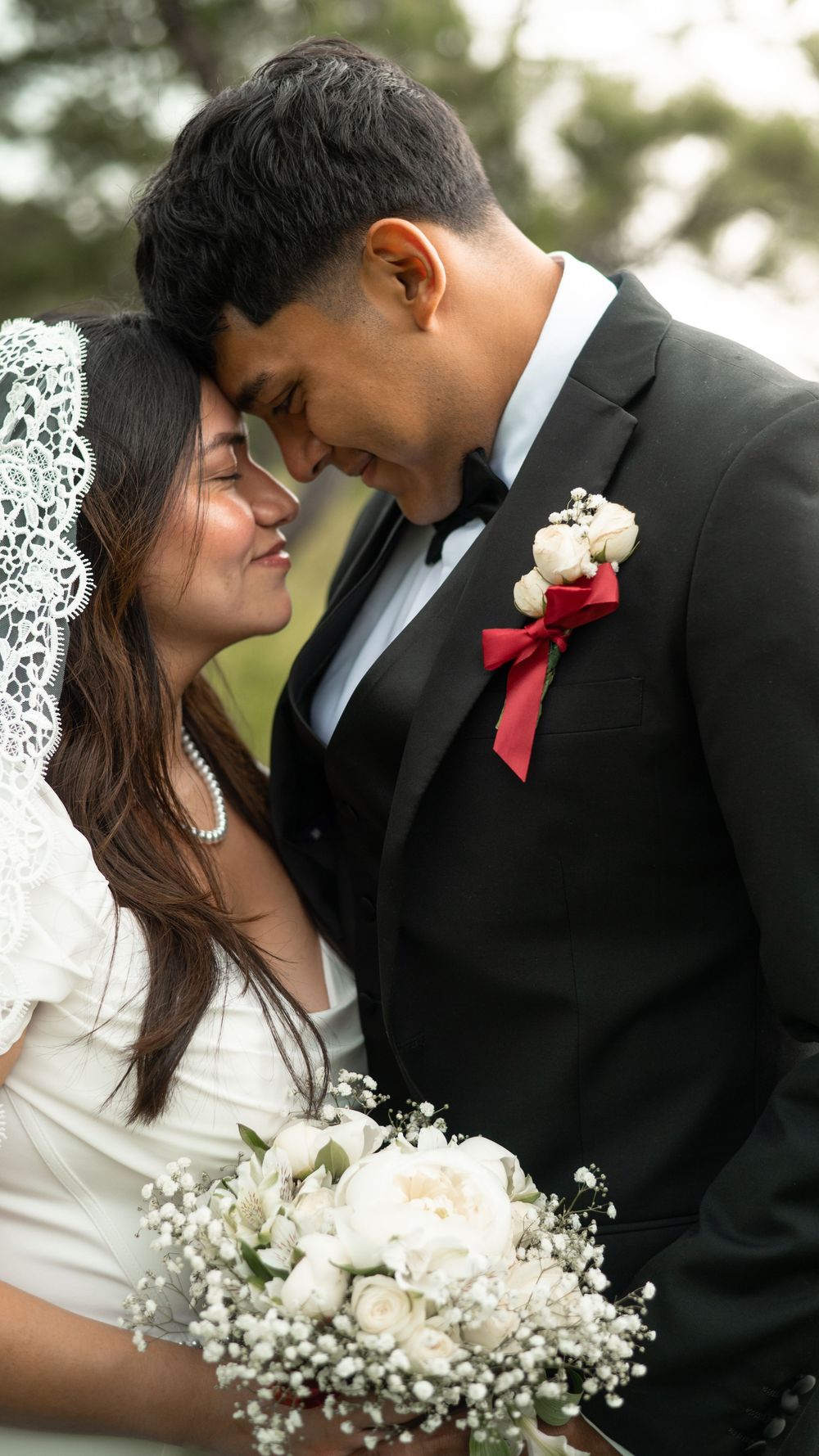 Romantic wedding portrait series showing tender moments between newlyweds with white bouquet and black tuxedo details.