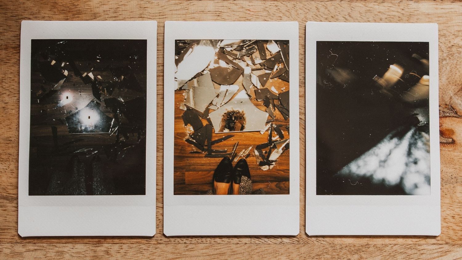 Three photo prints showing a dark night scene, climbing figure in amber lighting, and moody moonlit scene.