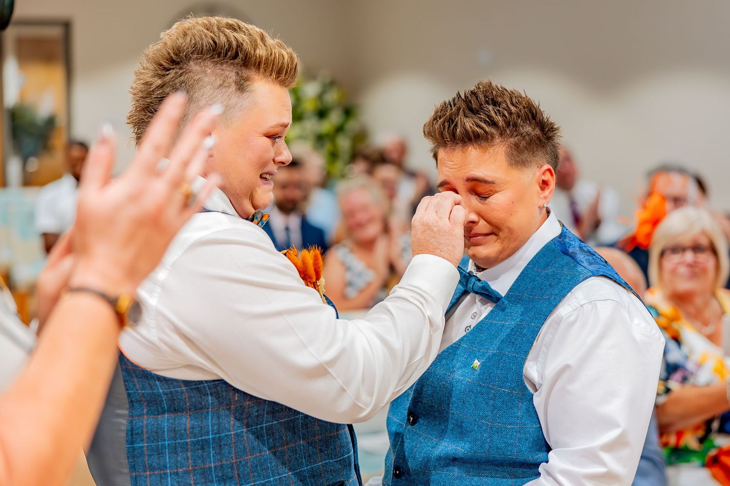 Natural emotional moment during wedding ceremony.