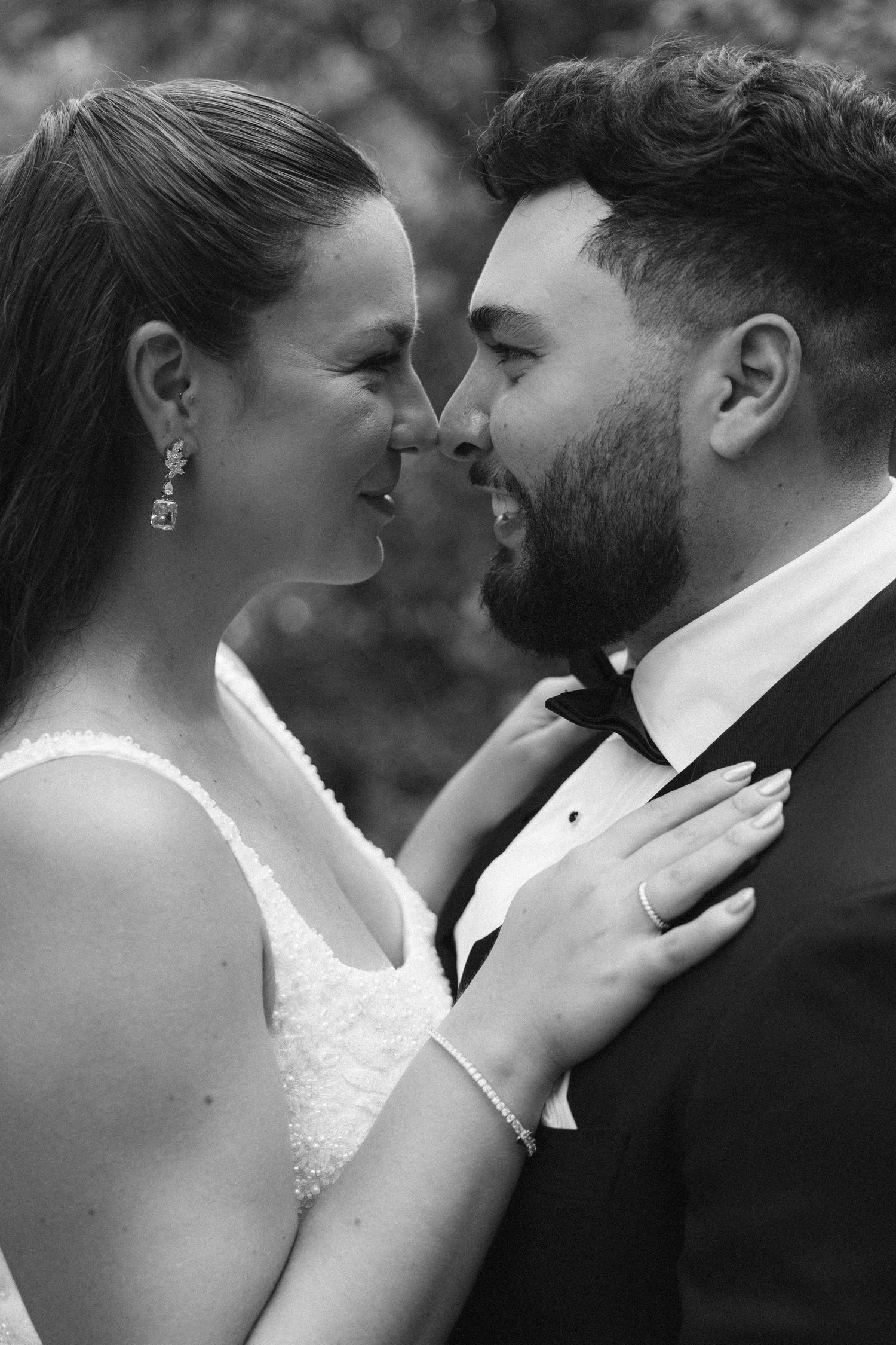 A romantic black and white wedding photo series showing intimate close-up moments between newlyweds.