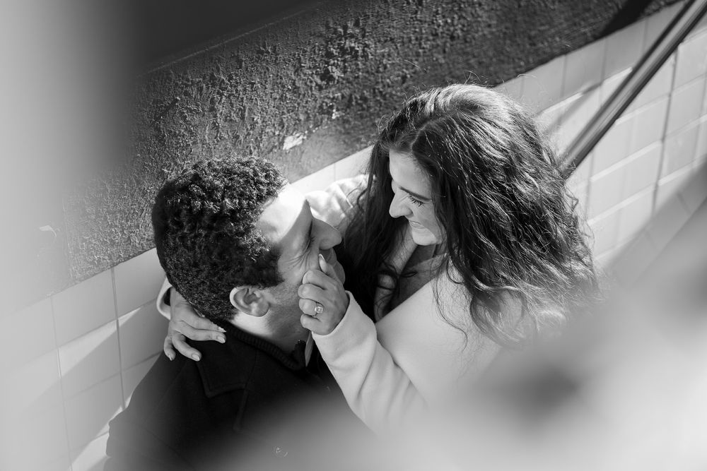 A black and white photo sequence shows a couple in an intimate embrace and kiss against a light background.