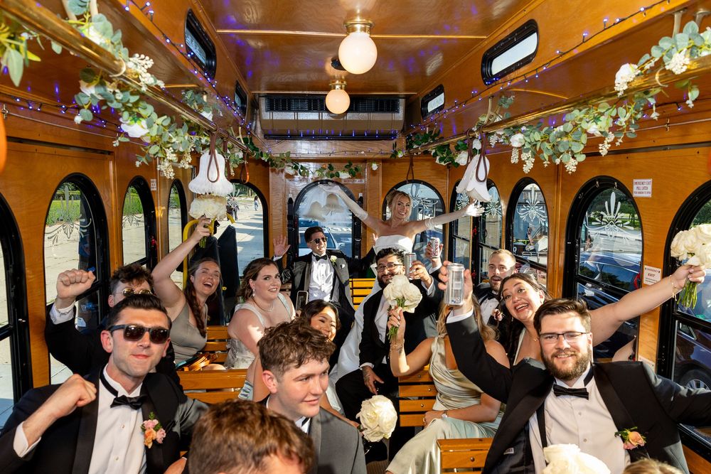 Crowded bar or restaurant interior with festive lighting and patrons celebrating in a warm, energetic atmosphere.