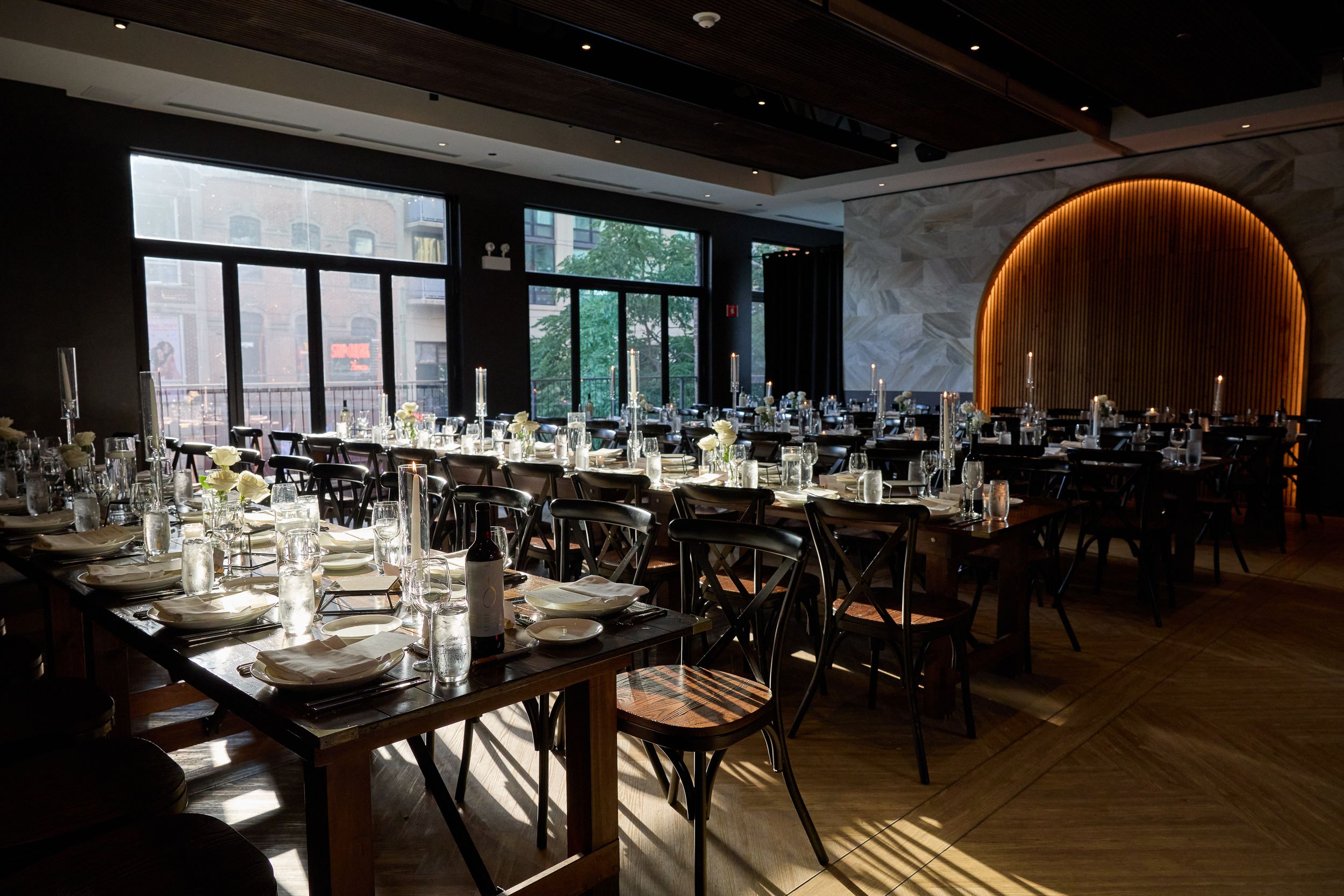 Modern restaurant interior with elegant table settings and dramatic lighting creates an upscale dining atmosphere.