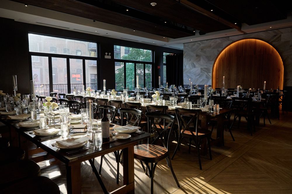 Modern restaurant interior with elegant table settings and dramatic lighting creates an upscale dining atmosphere.