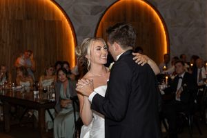 Wedding reception dance with warm orange uplighting creating an intimate atmosphere on the dance floor.