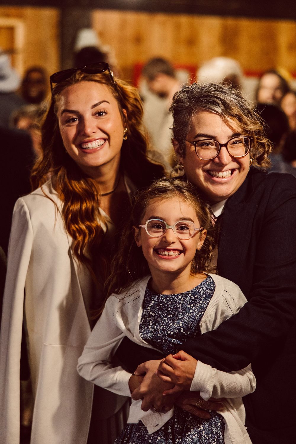Joyful moments captured at an evening celebration with warm lighting and festive attire.