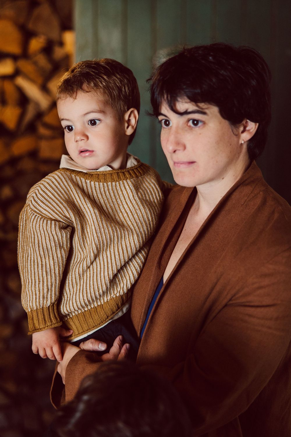 Warm toned portrait series showing tender moments between parent and child in matching brown and beige tones.