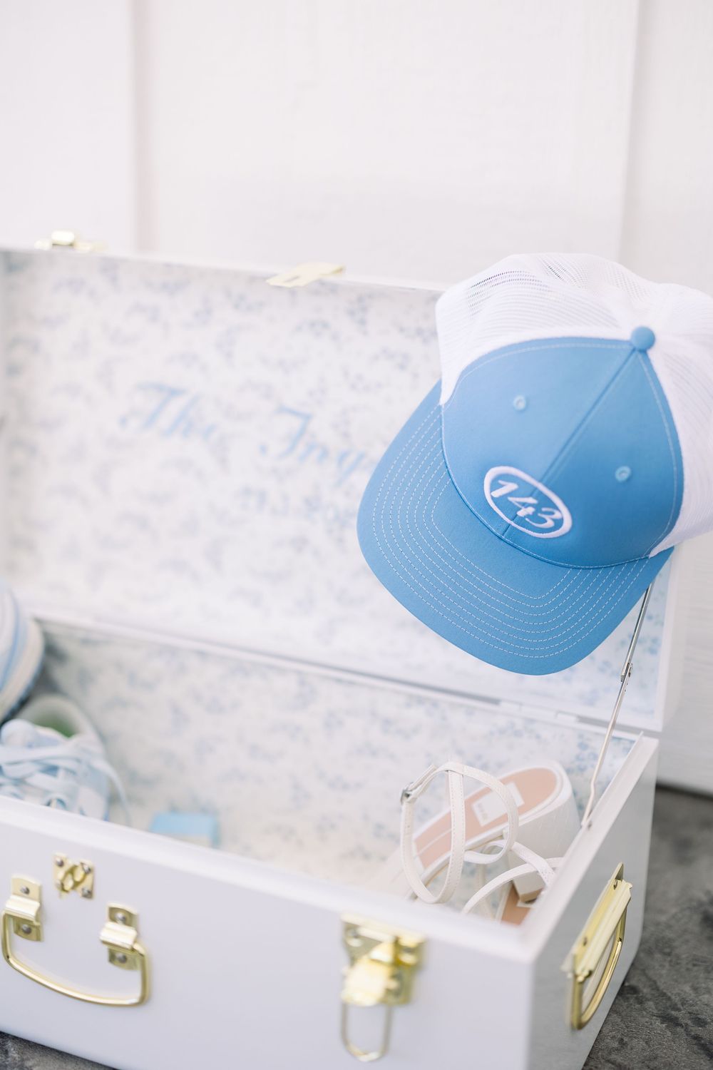 Light blue baseball cap displayed on a white surface with soft lighting.
