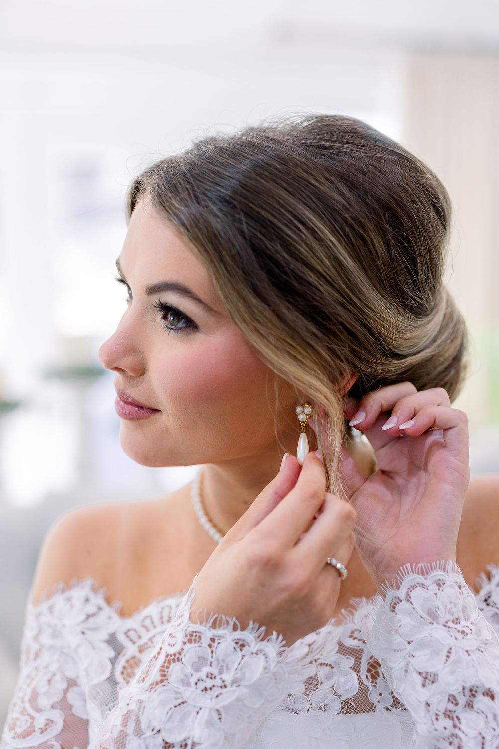 Close-up shots of delicate lace details and jewelry being put on for a wedding.
