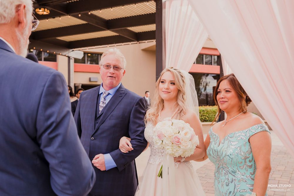 A series of candid wedding moments captured at a rustic indoor venue with exposed brick walls and white draping.