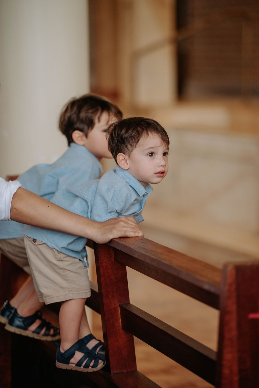 A small child in blue shirt and khaki shorts leans on a wooden bench in a sequence of candid shots.
