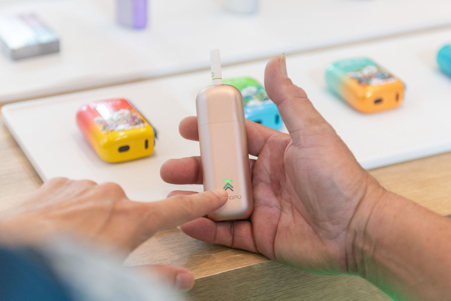 A sequence of hands using colorful blocks to demonstrate a step-by-step process on a white surface.