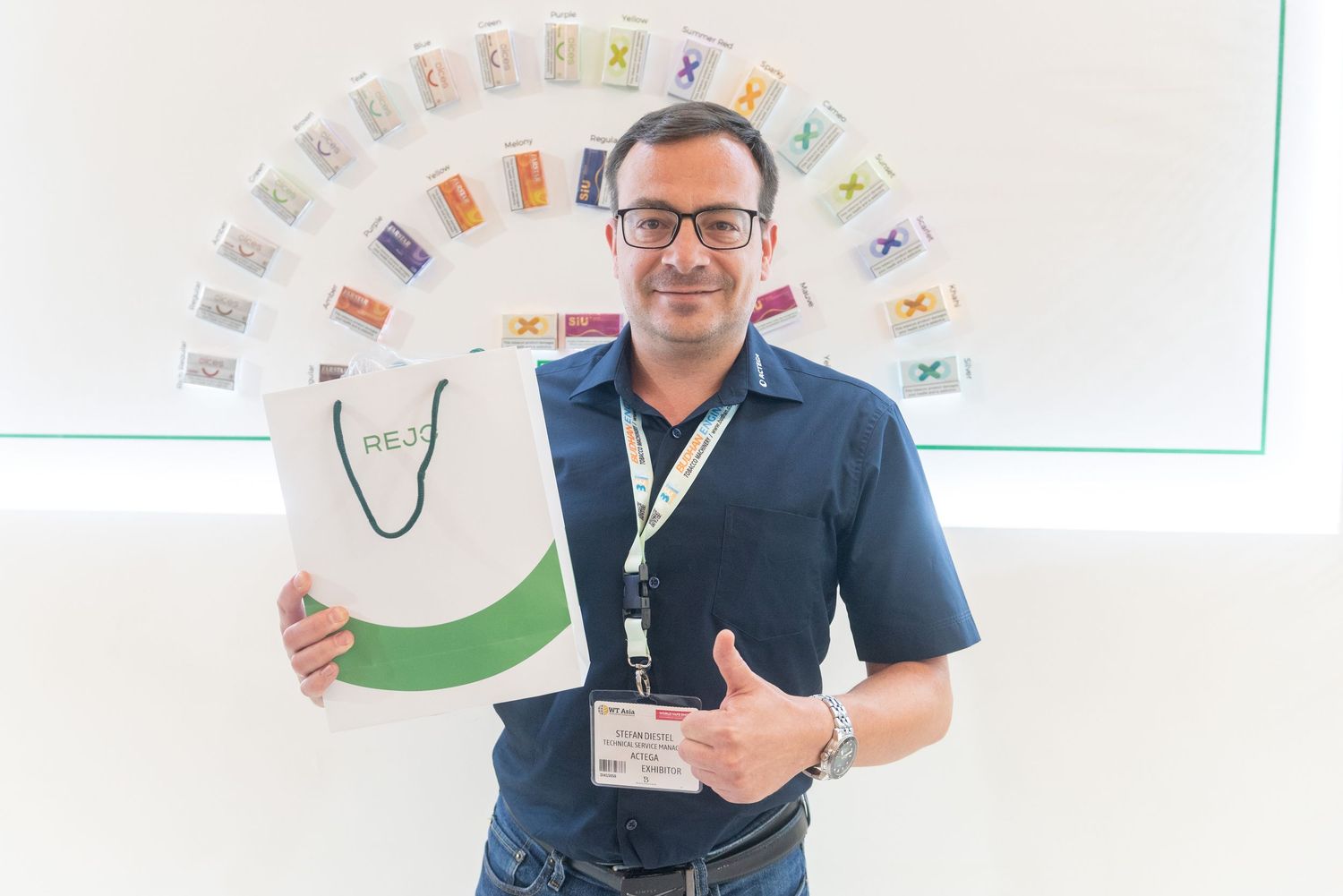 Teacher displays colorful educational cards in a bright classroom setting during an engaging lesson presentation.
