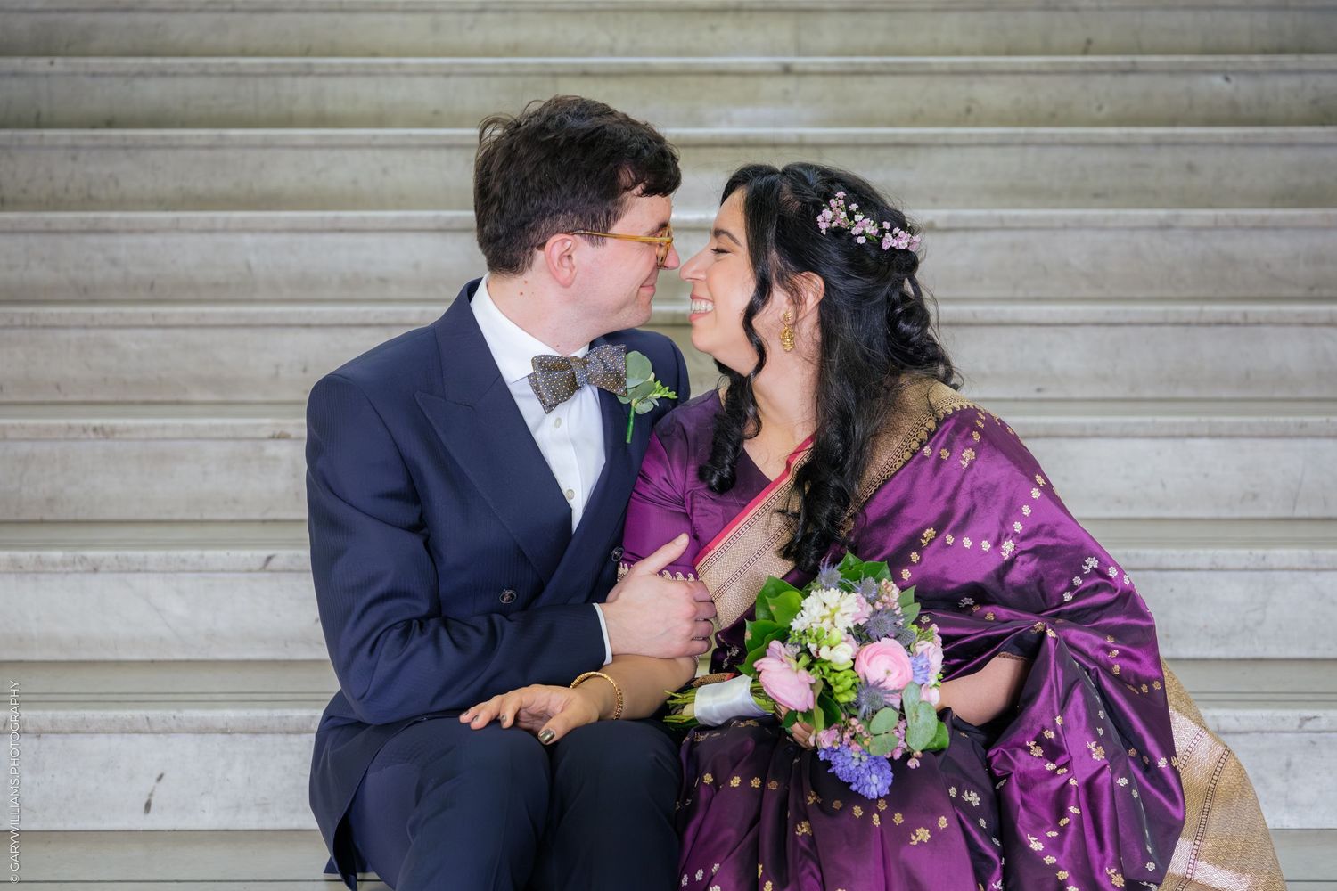Couple sharing romantic kisses in a series of photos against a stone wall backdrop.