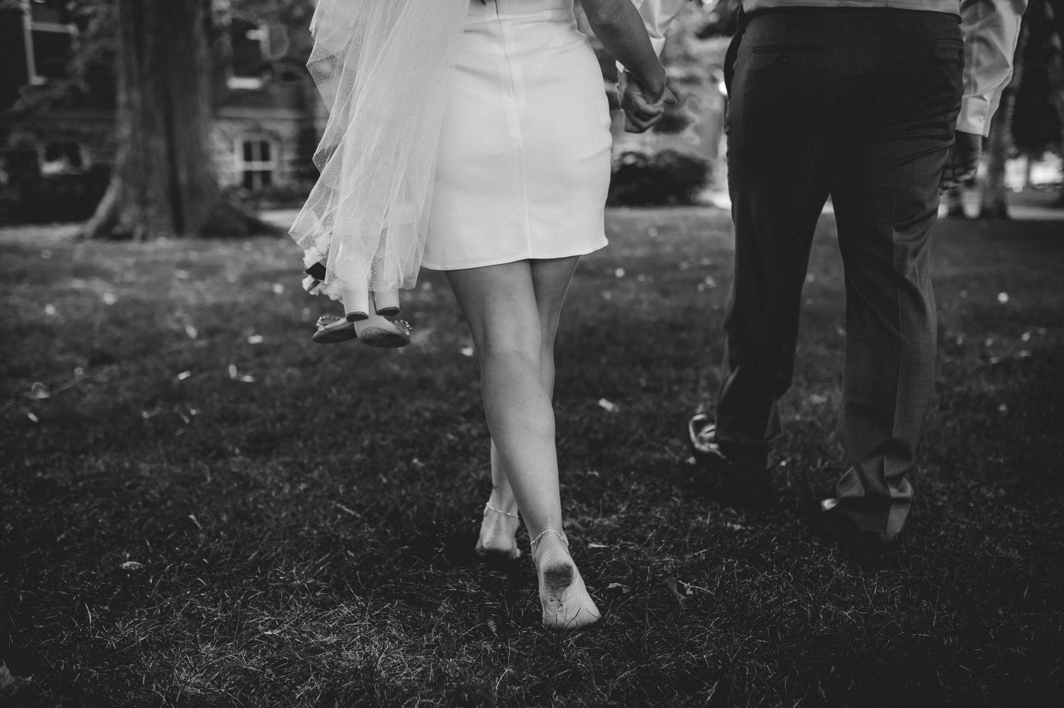 A black and white photo strip showing a couple walking together through a park or garden setting.