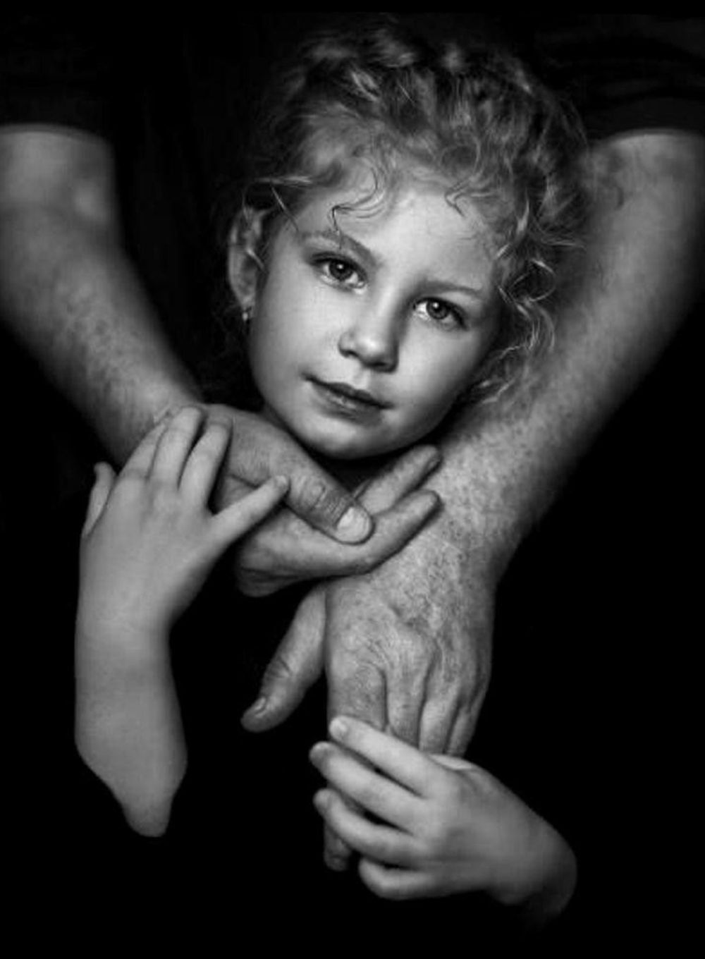 Black and white artistic photo series showing gentle hands cradling a child's face in various intimate poses.