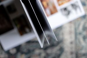 A group of polaroid style photos arranged in a scattered pattern on a dark surface.